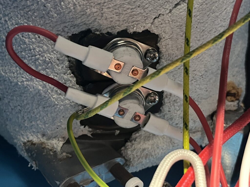 Two round thermal devices mounted to the insulated ST-750 pressure boiler with electrical connections visible