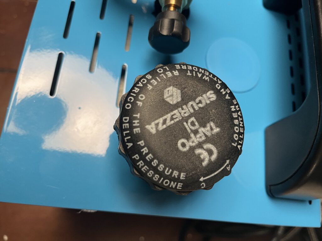 Close-up of ST-750 boiler fill cap showing pressure warning markings