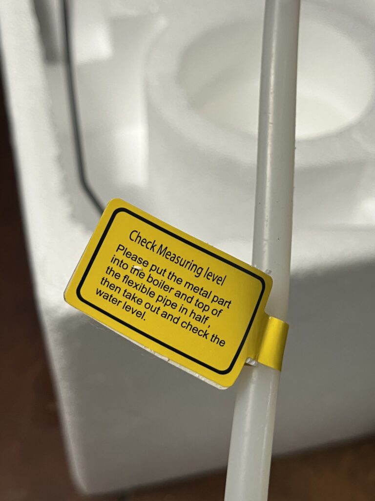 Close-up of ST-750 water-level dipstick instruction tag
