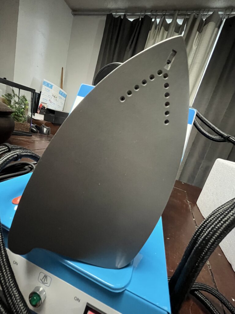 Soleplate of ST-750 steam iron showing steam outlet holes near the pointed end