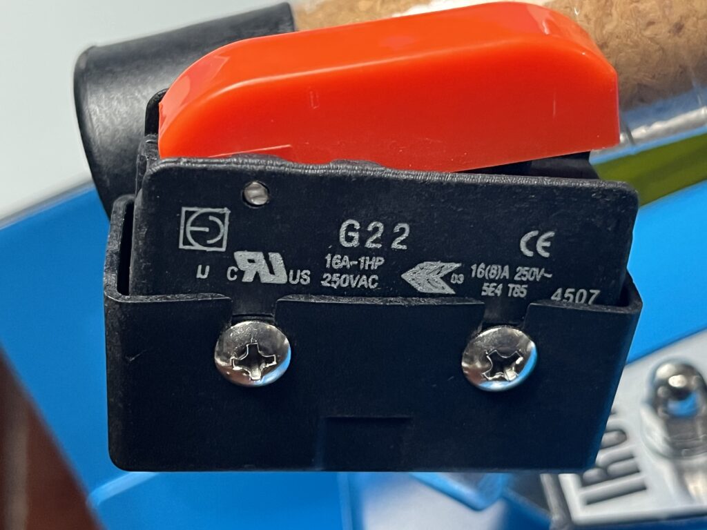 Close-up of ST-750 iron steam control showing red hand control and G22 microswitch markings