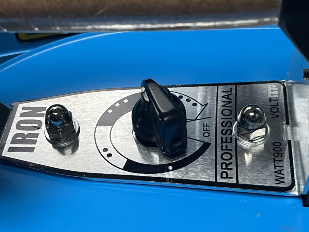 Close-up of the ST-750 iron temperature-control dial showing OFF position and graduated heat settings