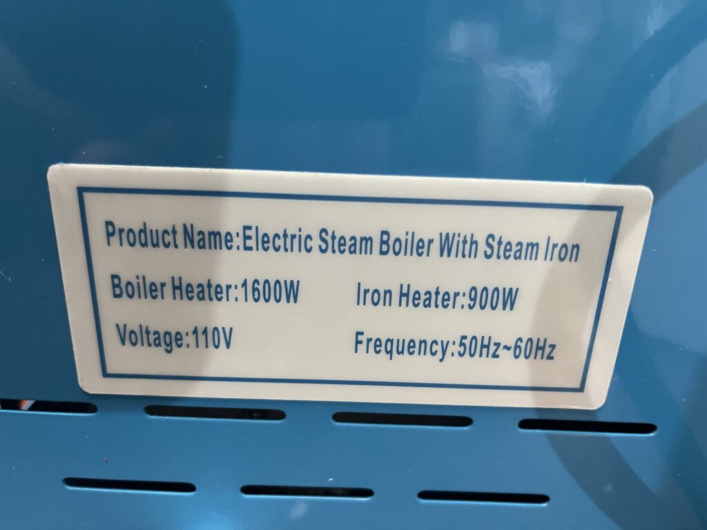 ST-750 specification label showing 1600 watt boiler heater, 900 watt iron heater, 110 volts, and 50 to 60 hertz