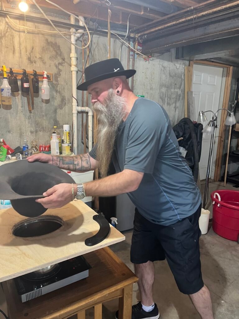 Preparing the 100% beaver felt body for blocking with steam during the Walton hat-making workshop.