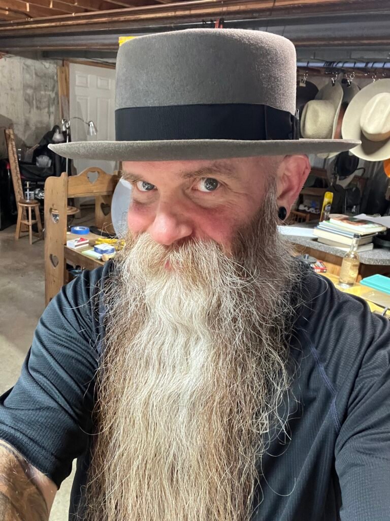 Patrick wearing a handmade felt hat during the Walton, Kentucky hat-making workshop.