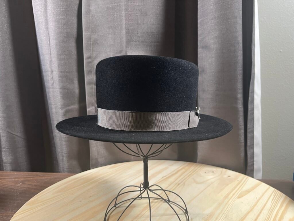 Finished black 100% rabbit pork pie with gray grosgrain ribbon and Maker’s Sword, Project PM-26-010.