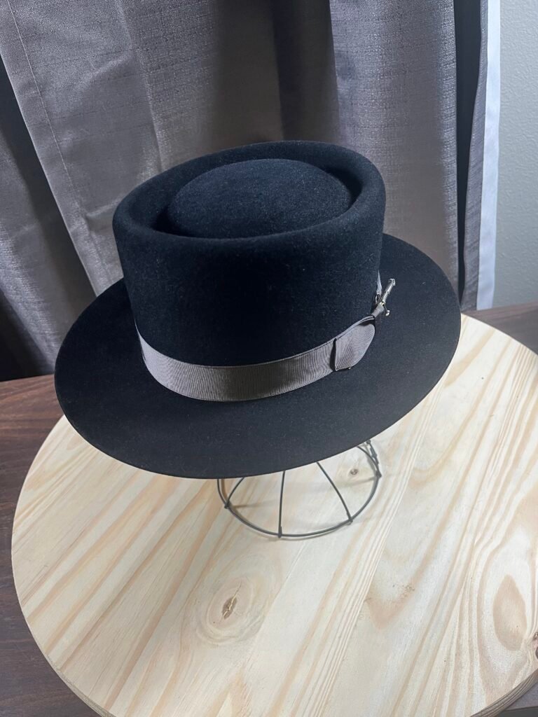 Top view of the finished black 100% rabbit pork pie showing the shaped crown and brim of Project PM-26-010.